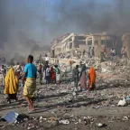 Civilians prepare to carry dead bodies of unidentified persons after an explosion in Mogadishu, Somalia.