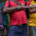 Tribal fighters stand in civilian clothes with their homemade gun in Papua New Guinea.