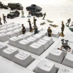 Toy soldiers on the buttons of a computer keyboard