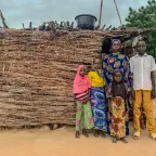 Fana Biri posing in front of her home with her children