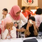 An emotional participant is comforted by an ICRC staff during one of the workshops. Credits: L. Arada/ICRC