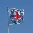 Emblem ICRC flad and blue sky
