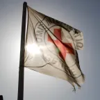 Emblem ICRC flag with sun behind