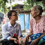 An ICRC worker with a woman in Myanmar