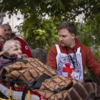 Mykolaiv. An ICRC staff member is talking to an old lady while she is being transferred to a new specialized facility. Mykolaiv. An ICRC staff member is talking to an old lady while she is being transferred to a new specialized facility.