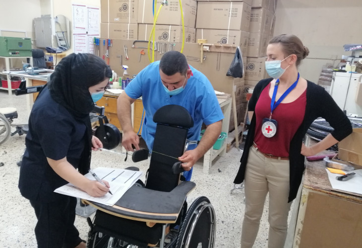 Rieke (right) with Shaema (wheelchair technician) and Omar (physio) preparing a specialized wheelchair for a child with cerebral palsy