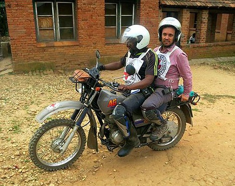 Béni, North Kivu, 2014. ICRC head of office Arnaud Meggre rides pillion after a visit to Masika, Lubero, which is completely inaccessible by car.