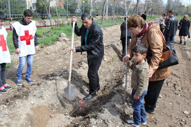 Armavir, Armenia. Karine Zaderyan plants a tree with her son and her grandson. Avetis is named after his missing grandfather.