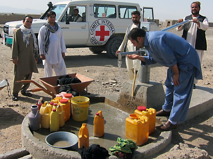 Kurji, Farah Province, Afghanistan. Technicians repair a handpump.